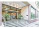 Building entrance featuring large windows and glass doors and stone stairs at 300 Peachtree St # Apt 9D, Atlanta, GA 30308