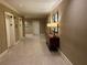 Well-lit elevator lobby with decorative lamps on the side table and elevator doors on the left at 300 Peachtree St # Apt 9D, Atlanta, GA 30308