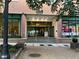 Entrance to Peachtree Towers featuring detailed marble facade and glass doors with retail surrounding entrance at 300 Peachtree St # Apt 9D, Atlanta, GA 30308