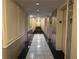 Long hallway with black and white floors and elevator access at 300 Peachtree St # Apt 9D, Atlanta, GA 30308