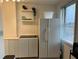 Kitchen featuring a white refrigerator, cabinets, shelves, and a window providing natural light at 300 Peachtree St # Apt 9D, Atlanta, GA 30308