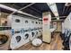 Functional laundry room with multiple washers and dryers for residents' convenience at 300 Peachtree St # Apt 9D, Atlanta, GA 30308