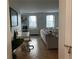 Cozy living room featuring hardwood floors, windows with blinds, and neutral-toned furniture at 300 Peachtree St # Apt 9D, Atlanta, GA 30308