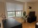 Living room with city views, hardwood floors, fresh paint, and television at 300 Peachtree St # Apt 9D, Atlanta, GA 30308