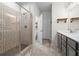 Spa-like bathroom featuring a glass shower with patterned tile and double sink vanity at 4554 Grenadine Cir, Acworth, GA 30101