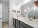 Bright bathroom with double vanity, decorative pipe shelving, and tile shower at 4554 Grenadine Cir, Acworth, GA 30101