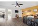 Open concept bonus room with wood floors and yellow accent wall is perfect for home office at 4554 Grenadine Cir, Acworth, GA 30101