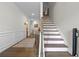 Inviting foyer with hardwood floors, elegant wainscoting, and a staircase leading to the upper level at 4554 Grenadine Cir, Acworth, GA 30101