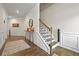 Welcoming foyer with hardwood floors, decorative rug, staircase, and elegant wainscoting at 4554 Grenadine Cir, Acworth, GA 30101