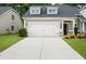 Charming home featuring a two-car garage with a concrete driveway and well-maintained landscaping at 4554 Grenadine Cir, Acworth, GA 30101
