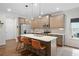 Elegant kitchen featuring a center island with bar seating, stainless steel appliances, and stylish pendant lighting at 4554 Grenadine Cir, Acworth, GA 30101