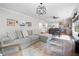 Open concept living area with a comfortable sectional sofa, hardwood floors, and modern lighting at 4554 Grenadine Cir, Acworth, GA 30101