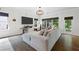 Bright living room with hardwood floors, modern light fixture, and large sectional sofa at 4554 Grenadine Cir, Acworth, GA 30101