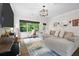 Cozy living room featuring a comfortable sectional, hardwood floors, and stylish décor at 4554 Grenadine Cir, Acworth, GA 30101