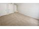 Spacious bedroom featuring neutral carpet and two white doors and a glimpse into another room at 501 Vicksburg Pl, Atlanta, GA 30350