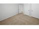 Bedroom featuring two white doors and neutral carpet; the possibilities are endless in this space at 501 Vicksburg Pl, Atlanta, GA 30350