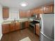 Kitchen with stainless steel appliances, granite countertops, and wood cabinets at 501 Vicksburg Pl, Atlanta, GA 30350