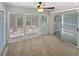 Bright living room featuring large windows, neutral carpet, and sliding glass door to outdoor space at 501 Vicksburg Pl, Atlanta, GA 30350