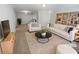 Bright living room featuring a modern couch, chairs, and bookshelf at 501 Vicksburg Pl, Atlanta, GA 30350