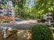 Parking lot with mature trees surrounding the condo buildings at 501 Vicksburg Pl, Atlanta, GA 30350