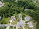Aerial view of the neighborhood showcasing its well-maintained streets and green spaces in a wooded area at 521 Andes Ln, Canton, GA 30114