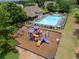 Aerial view of a community pool, a splash pool, a playground, mature trees, and a well-maintained lawn at 521 Andes Ln, Canton, GA 30114