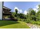 Spacious backyard with upper deck featuring screened porch and stairs to the lawn at 521 Andes Ln, Canton, GA 30114