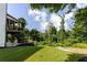 Backyard featuring upper deck with screened porch, grassy area, and mature trees at 521 Andes Ln, Canton, GA 30114