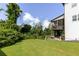 Well-manicured lawn leads to upper deck with screened porch and patio below, perfect for outdoor enjoyment at 521 Andes Ln, Canton, GA 30114
