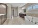 Luxurious bathroom featuring a soaking tub, double vanity, and modern tile flooring at 521 Andes Ln, Canton, GA 30114