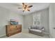 Neutral bedroom featuring plantation shutters, carpet, and a ceiling fan, perfect for comfort and relaxation at 521 Andes Ln, Canton, GA 30114