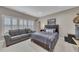 Spacious bedroom with a bed, comfortable seating area, and ample natural light, ideal for relaxation at 521 Andes Ln, Canton, GA 30114