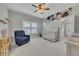 Cozy Bedroom with a crib, glider chair, and floral accent wall creating a serene and inviting space at 521 Andes Ln, Canton, GA 30114
