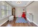 Versatile bonus room with hardwood floors, ample natural light, and playful decor elements like a Coca-Cola machine at 521 Andes Ln, Canton, GA 30114