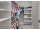 Organized walk-in closet with shelving and hanging space for efficient storage and easy access at 521 Andes Ln, Canton, GA 30114
