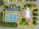 Aerial view showcasing community amenities: tennis courts, a clubhouse, a swimming pool, a kiddie pool, and a playground at 521 Andes Ln, Canton, GA 30114