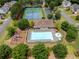 Aerial view of the community pool, tennis courts, and playground, showcasing the neighborhood's recreational offerings at 521 Andes Ln, Canton, GA 30114