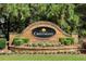 Elegant stone sign for Crestmont community, surrounded by beautiful landscaping and flowers at 521 Andes Ln, Canton, GA 30114