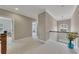 Upstairs hallway featuring neutral paint, white carpet and a modern chandelier at 521 Andes Ln, Canton, GA 30114