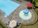 Aerial view of a mushroom fountain in the community's kiddie pool surrounded by chairs and umbrellas near the larger pool at 521 Andes Ln, Canton, GA 30114
