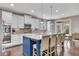 Stylish kitchen with white cabinets, stainless steel appliances, granite countertops, and a blue island at 521 Andes Ln, Canton, GA 30114