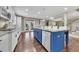 Modern kitchen with a blue island, granite countertops, white cabinets, and stainless steel appliances at 521 Andes Ln, Canton, GA 30114