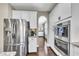 Beautiful kitchen featuring stainless steel appliances, white cabinets, and an arched entryway into another room at 521 Andes Ln, Canton, GA 30114