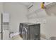 Convenient laundry room equipped with modern washer and dryer units and additional shelving at 521 Andes Ln, Canton, GA 30114