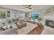Comfortable living room featuring a fireplace, plantation shutters and hardwood floors at 521 Andes Ln, Canton, GA 30114