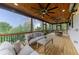 Large, screened patio overlooking backyard featuring ceiling fans and comfortable seating at 521 Andes Ln, Canton, GA 30114