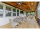 Covered patio with wood ceiling, dining table, and comfortable seating area for outdoor relaxation at 521 Andes Ln, Canton, GA 30114