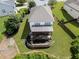 Aerial view showing the home's rear exterior with a large, well-kept lawn and outdoor living spaces at 521 Andes Ln, Canton, GA 30114