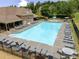 Aerial view showcasing a community pool with lounge chairs, a splash pool with a fountain, and clubhouse at 521 Andes Ln, Canton, GA 30114