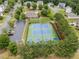 Aerial view of community tennis courts with neighborhood homes, clubhouse, swimming pool, and parking in the background at 521 Andes Ln, Canton, GA 30114